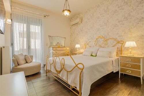 a bedroom with a large bed and a chair at Morita Luxury Apartment in Heraklio