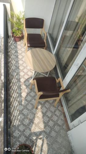 two chairs and a table on a balcony at HOTEL METTEYYE RESIDENCY in Padrauna