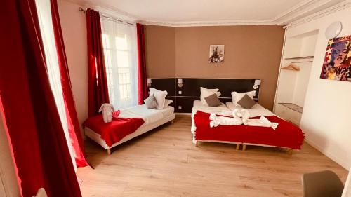 a bedroom with two beds and red curtains at Jeff Hotel in Paris