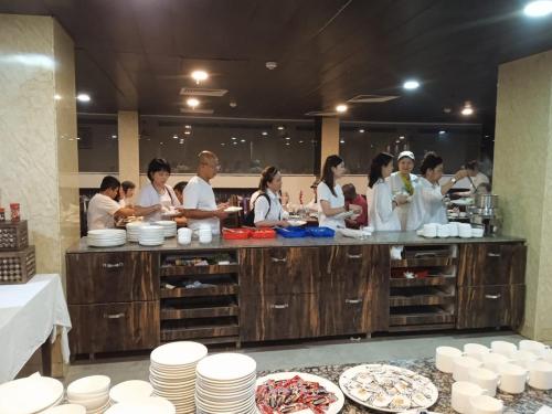 a group of people in a kitchen preparing food at HOTEL METTEYYE RESIDENCY in Padrauna
