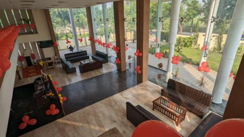 an overhead view of a living room with red decorations at HOTEL METTEYYE RESIDENCY in Padrauna