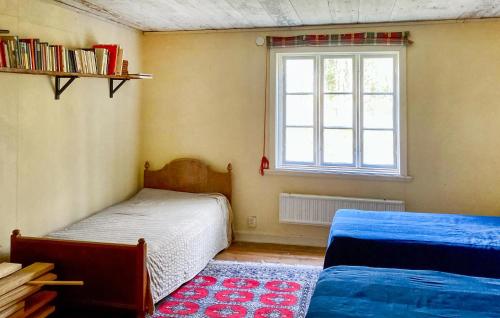 a bedroom with two beds and a window at Lovely Home In Vittinge With Wifi 