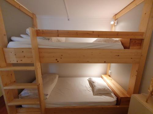 a couple of bunk beds in a room at Impact Beach House in Estoril