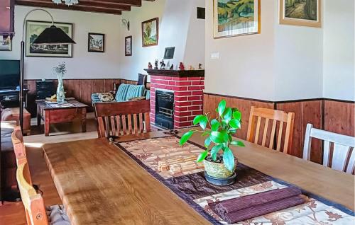 a living room with a table and a fireplace at Amazing Apartment In Chwarzenko in Chwarzenko