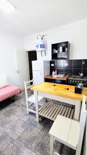 a kitchen with a wooden table and a stove at Departamento a una cuadra del mar MDP in Mar del Plata