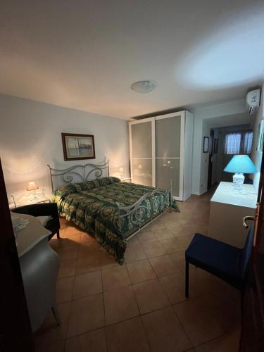 a bedroom with a bed with a green bedspread at Short let SanRocco in Olevano Romano