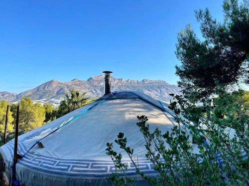a tent is set up with mountains in the background at Yurt in La Nucia met zwembad in La Nucía