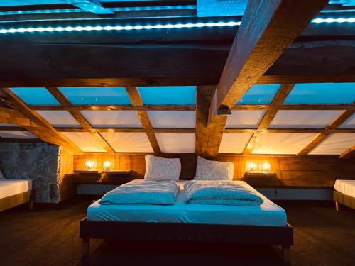 a bed in a room with a wooden ceiling at Appartement Sabrina in Steinberg am Rofan
