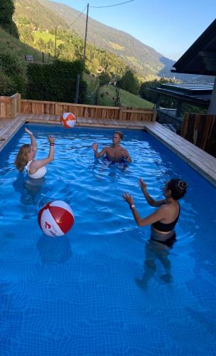 a group of people playing in a swimming pool at Haus Hoen in Untertweng