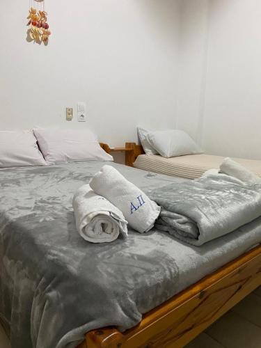 two beds with towels on them in a bedroom at Alexandra Studios in Néos Pírgos