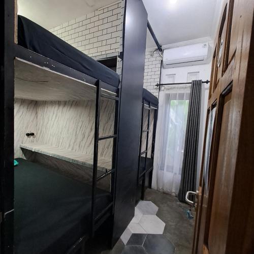 a room with a bunk bed and a door at RENJANA BED AND BREAKFAST in Yogyakarta