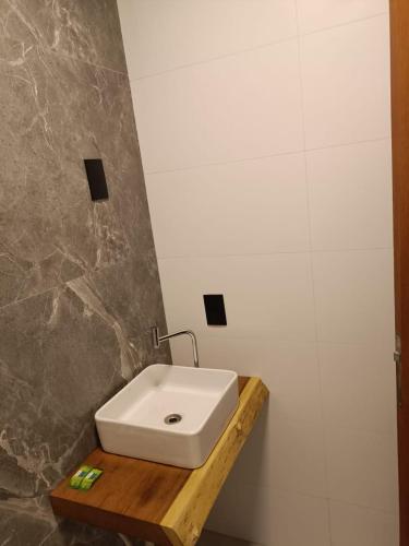 a bathroom with a white sink on a wooden counter at Cabanas THE VIEW in Santa Teresa