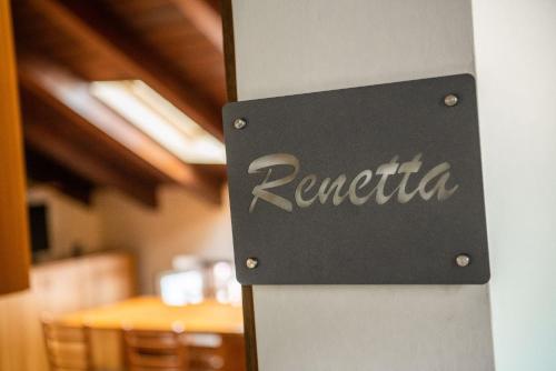 a sign for a restaurant on the side of a wall at Hotel Diffuso Locanda Elisa in Dimaro