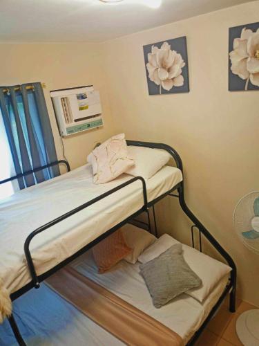a hospital room with two bunk beds in it at Entire 2BR condo 8 Spatial Maa Davao in Davao City
