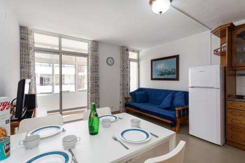 a living room with a table and a blue couch at TAC - Fisherman's Beach Apartment in Albufeira
