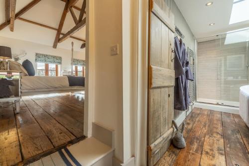 a hallway with wood floors and a sliding barn door at Little Star in Ringstead