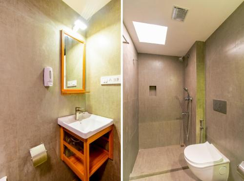 a bathroom with a toilet and a sink and a shower at Revaa Hotels in kolkata
