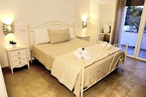 a bedroom with a bed with two towels on it at I 7 Peccati in Marina di Mancaversa