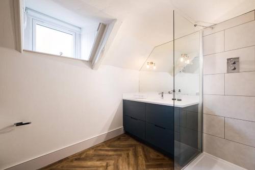 a bathroom with a sink and a glass shower at Great Escapes Oundle Flat 2 in Oundle