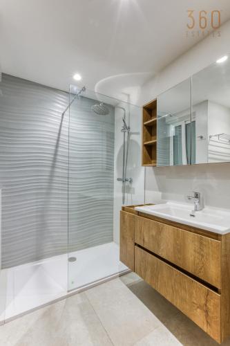 a bathroom with a shower and a sink at The Swieqi Poolside Suites in Is-Swieqi