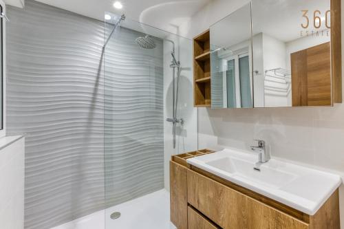 a bathroom with a sink and a shower at The Swieqi Poolside Suites in Is-Swieqi