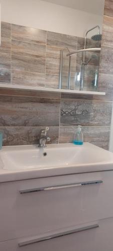 a bathroom with a sink and aaucet at Villa A&M in Vinišće