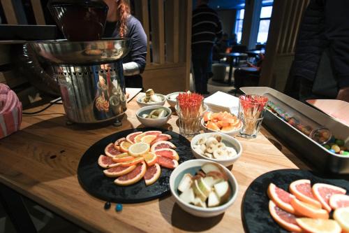 a wooden table with plates of food and a blender at Belambra Clubs Flaine Panorama in Flaine