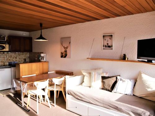 un salon avec un canapé et une table dans l'établissement Studio cabine au pied des pistes avec balcon et ascenseur à Auris en Oisans - FR-1-297-154, à Auris