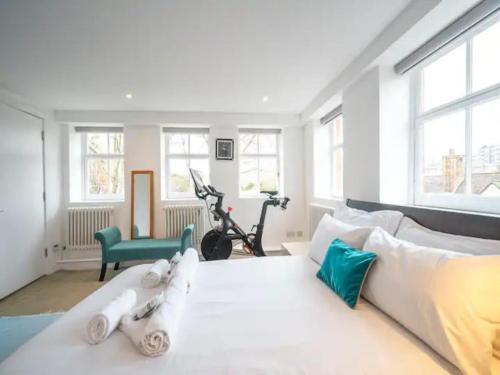 a living room with a white couch and some windows at Pass the Keys Kingsway Place - Stunning 1 Bedroom Duplex in London