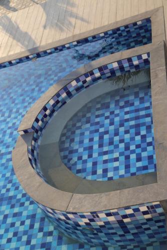 a swimming pool with a circle in the water at Suryaansh in Pālghar