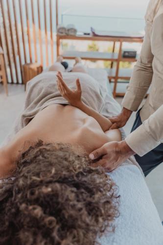 a man getting a massage in a bed at Korai Suites by Good Life in Heraklio Town
