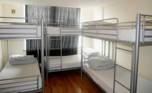 a bunk bed with two bunk beds in a room at Kensal Green Backpackers in London