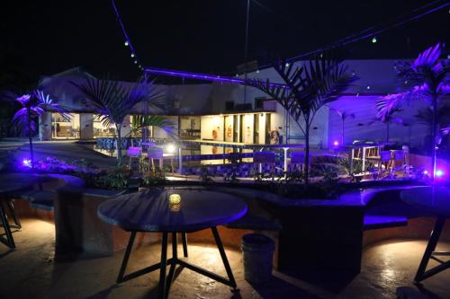 a bar with purple lights in front of a building at Suryaansh in Pālghar