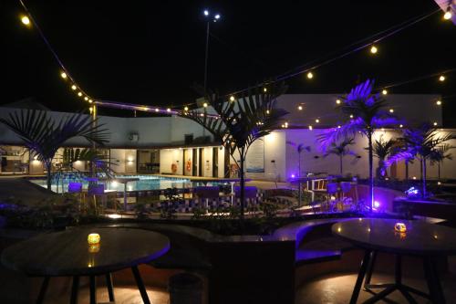 a patio with tables and lights at night at Suryaansh in Pālghar