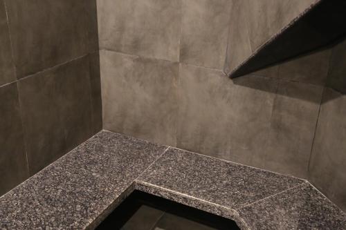 a bathroom with a shower with a marble shower sidx sidx sidx at Suryaansh in Pālghar