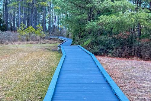 a wooden boardwalk in the middle of a field at White Creek at Bethany --- 30930 Sea Breeze Ln in Ocean View