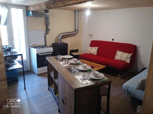 a living room with a table with wine glasses on it at Village où il fait bon de vivre in Mauléon-Barousse