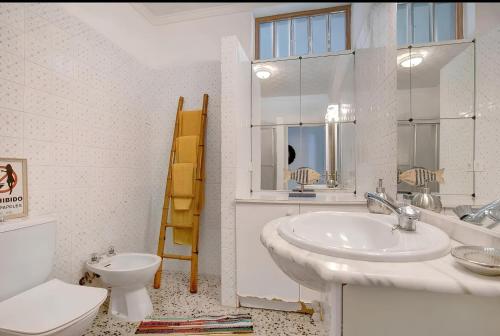 a bathroom with a sink and a toilet and a mirror at Tropical Oasis Villa Playa Paraiso in Playa Paraiso