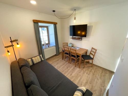 a living room with a couch and a table at Apartment House Prezlc in Kranjska Gora