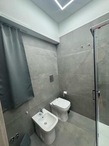 a bathroom with a toilet and a shower and a sink at Cliò guest house in Ercolano