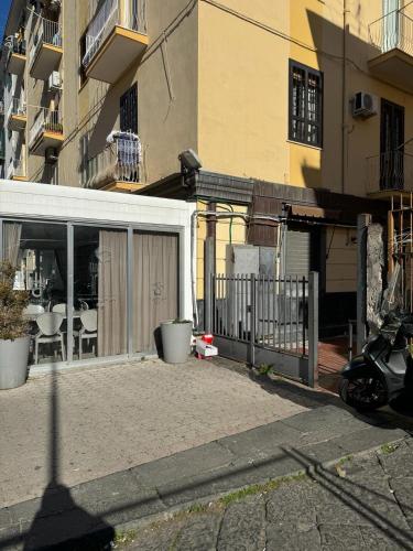 a building with a fence and a patio at Cliò guest house in Ercolano