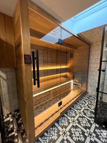 a sauna with a glass door in a building at Cracovia Luxury Bright Apartment Great Location Sauna in Krakow
