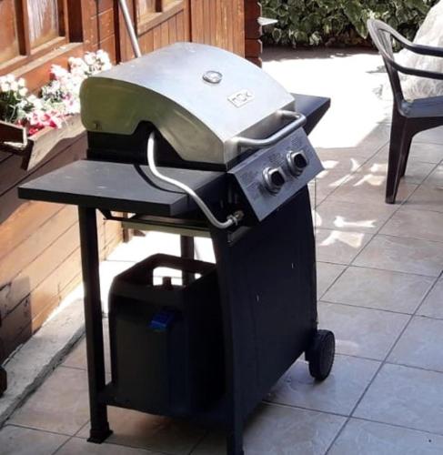 - un barbecue installé sur une table dans un patio dans l'établissement Charmant T3 en rez de jardin d'une villa, à Ghisonaccia