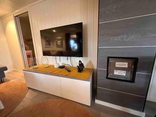 a bathroom with a counter with a mirror and a sink at KB Basement Apartment in Sørvågen