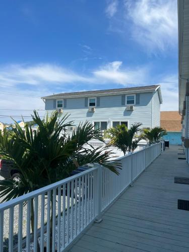 a house on a boardwalk next to the beach at Wave Villa in Chincoteague