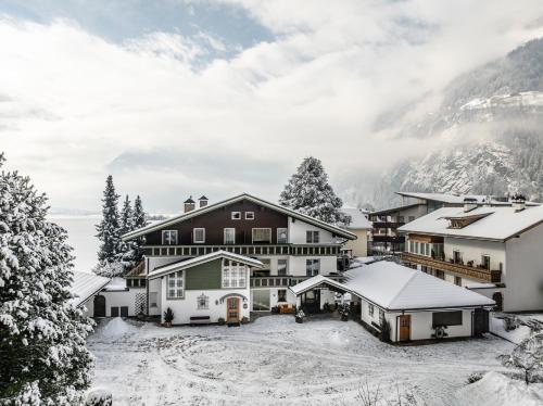 a house in the mountains with snow on the ground at Garni Zimmerhofer in Campo Tures