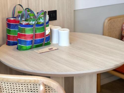 a table with colorful shopping bags on top of it at Boutech JianTan Hotel in Taipei