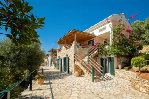 a house with a pathway leading up to it at Villa Giancarlo - Lovely Villa with Stone and Wood Elements in Sivota Bay in Sivota