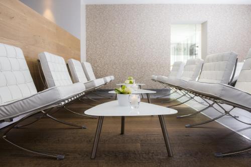 a row of chairs and tables in a waiting room at Hotel Florent in Lier