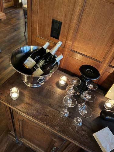 a bunch of wine bottles and glasses on a table at Manoir Nestor - Chairière in Vresse-sur-Semois